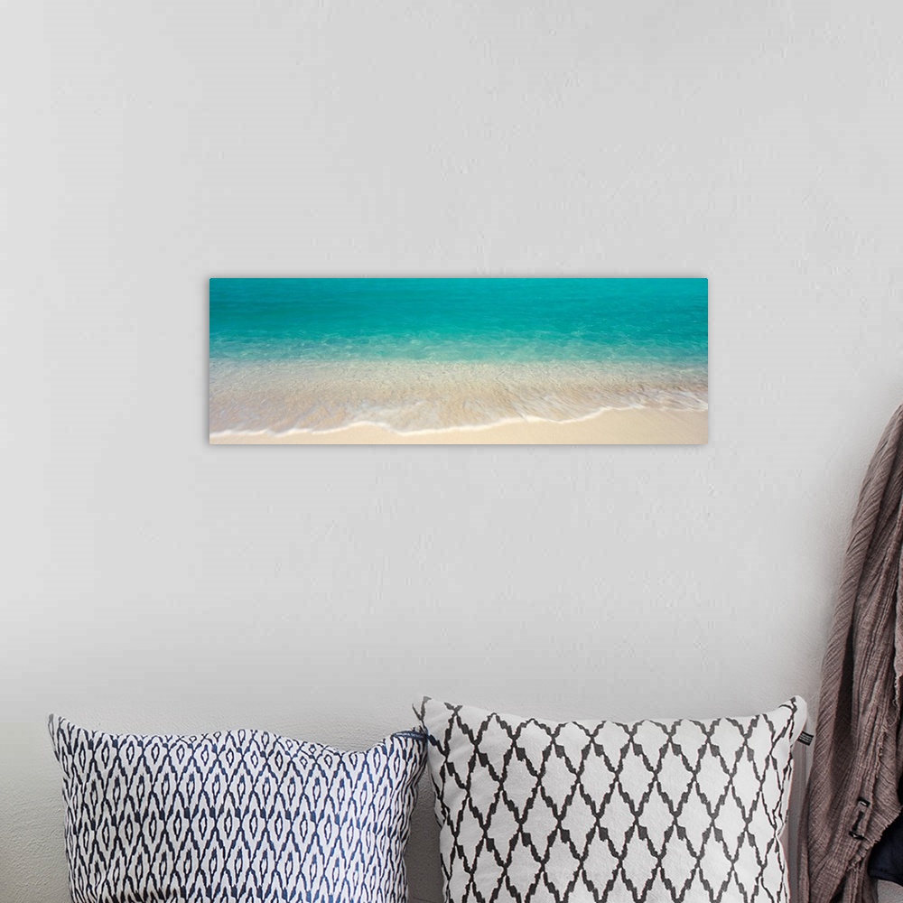 A bohemian room featuring Panoramic photograph displays the clear waters of the Atlantic Ocean gently crashing into the san...