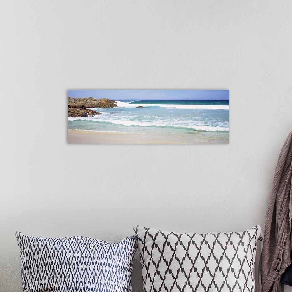 A bohemian room featuring Wide angle photograph of waves crashing into the beach, large rocks jutting into the waters in Au...