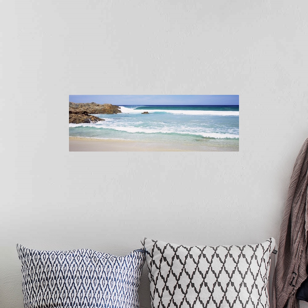 A bohemian room featuring Wide angle photograph of waves crashing into the beach, large rocks jutting into the waters in Au...
