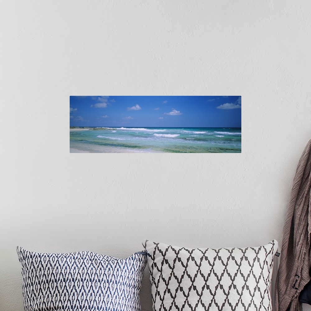 A bohemian room featuring Panoramic image of waves crashing on the beach.
