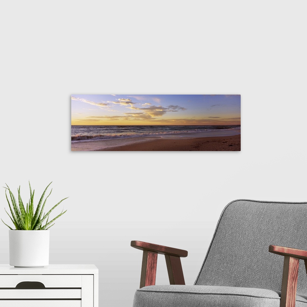 A modern room featuring Large, horizontal wall picture of waves of the Gulf of Mexico hitting the beach in Nokomis, Flori...