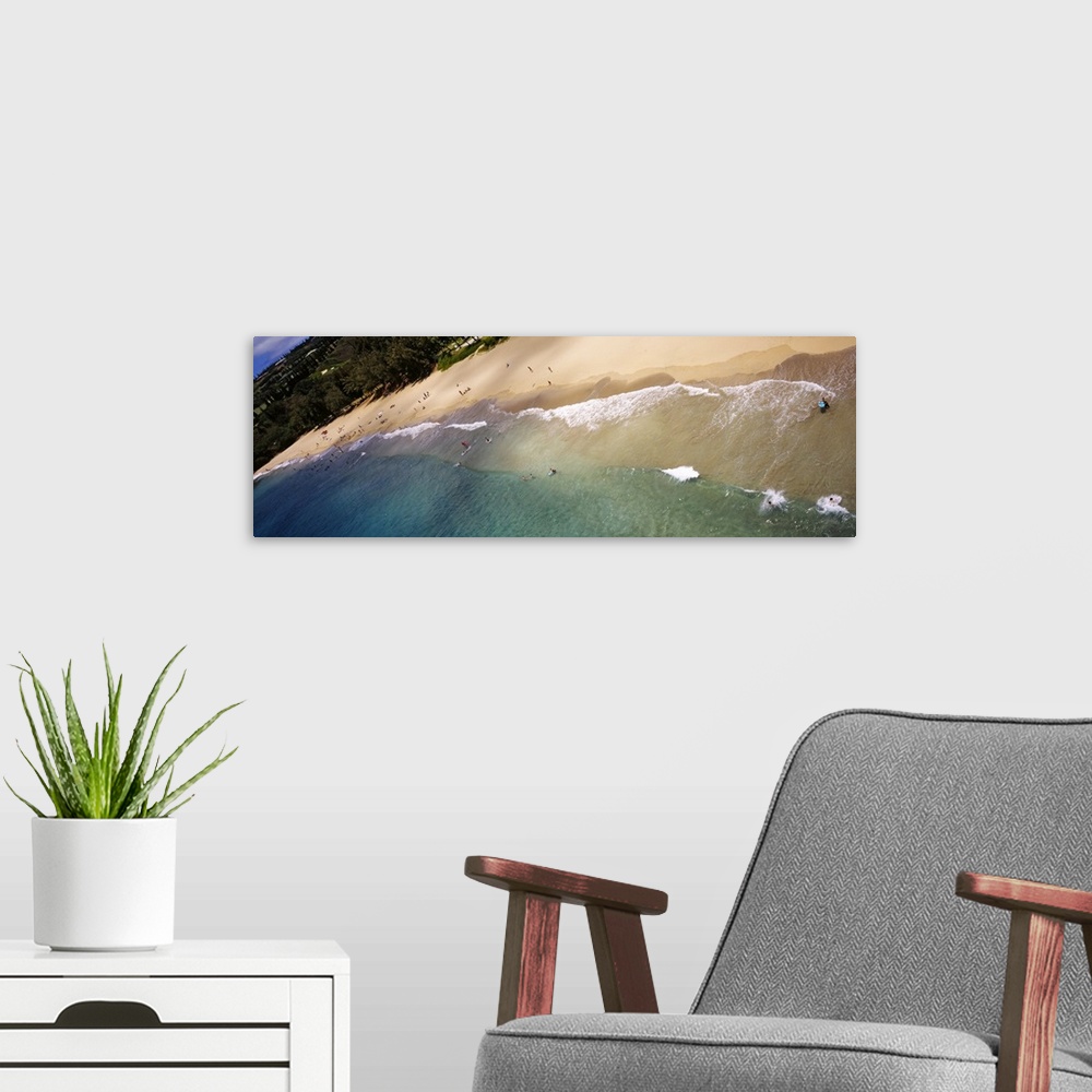 A modern room featuring Long photo on canvas of ocean waves crashing on the shore of a Hawaiian beach.