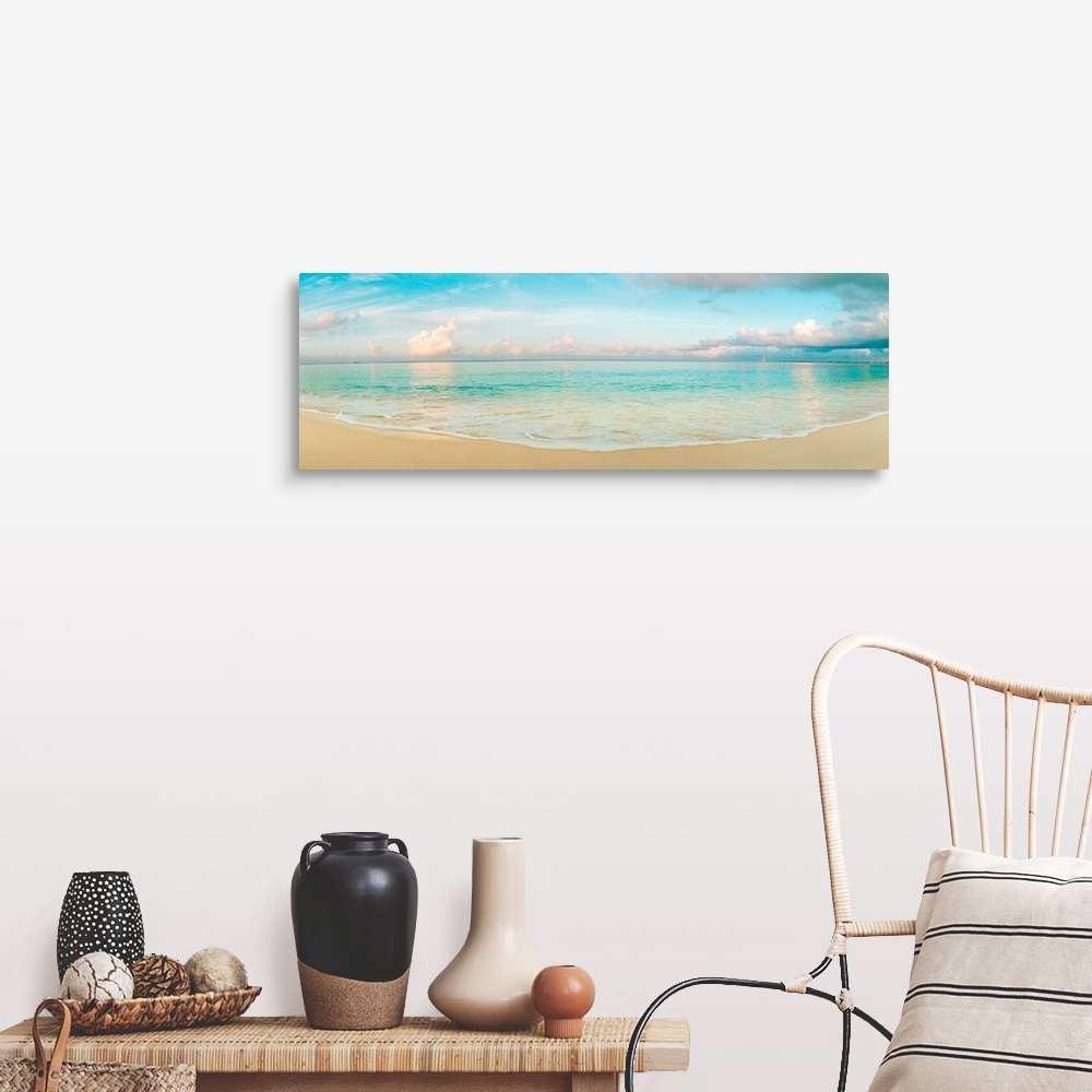 A farmhouse room featuring A wide angle panoramic wall hanging of a calm tropical ocean, waves on the beach, and cumulus clo...