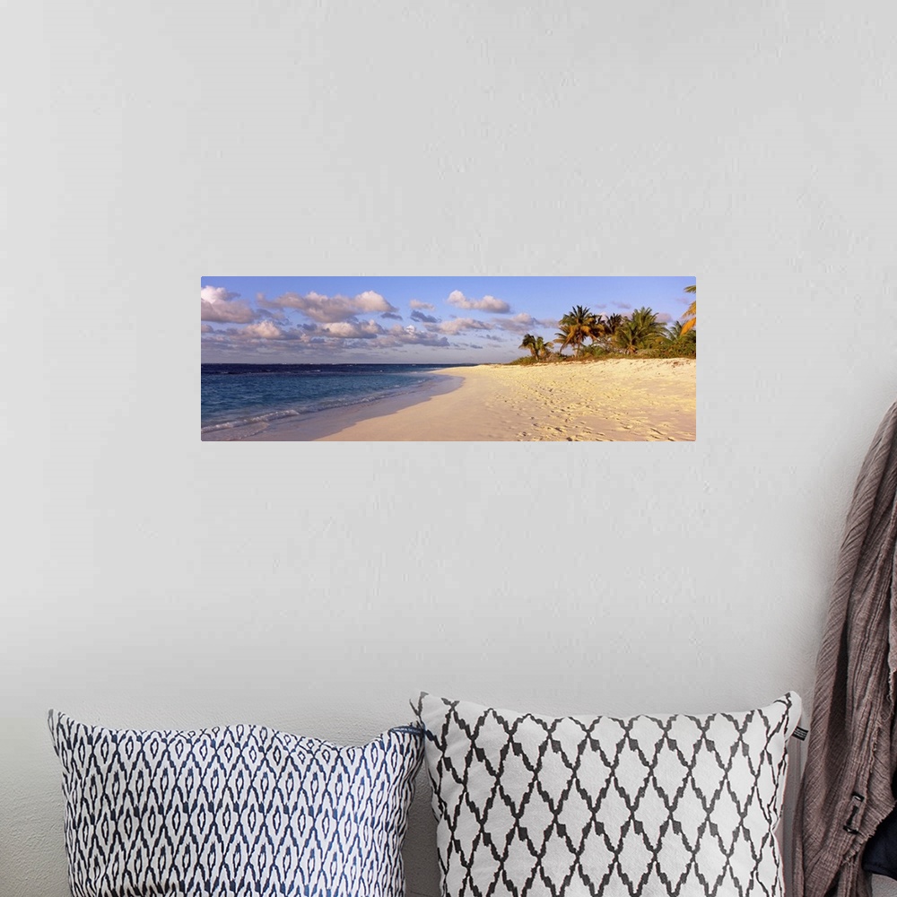 A bohemian room featuring Big panoramic photo of waves trickling onto the Shoal Bay Beach in Anguilla. Fooprints can be see...