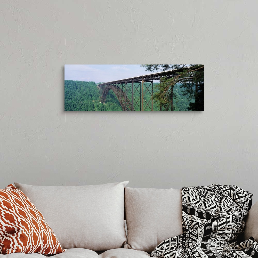 A bohemian room featuring Panoramic photograph of a dense forest of trees surrounding the base of New River Gorge Bridge in...