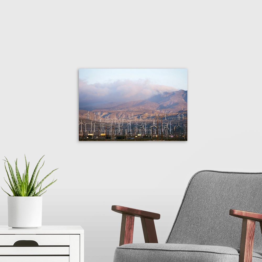 A modern room featuring Wind turbines with mountains in the background, Riverside County, California