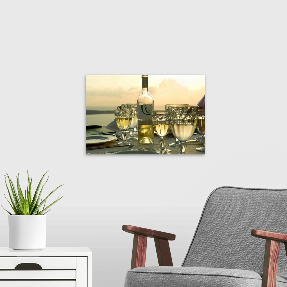 A modern room featuring Horizontal photograph on a big wall hanging of place settings on a  table, surrounded by many ful...
