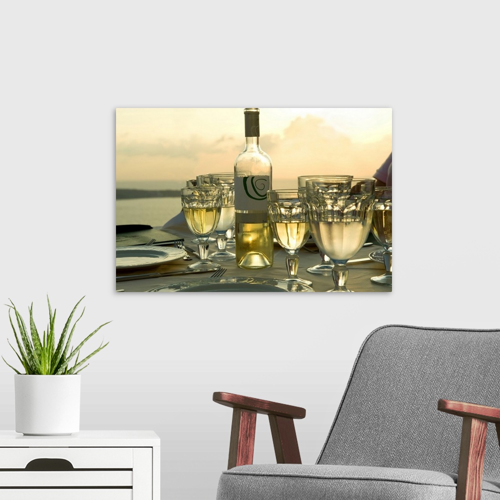 A modern room featuring Horizontal photograph on a big wall hanging of place settings on a  table, surrounded by many ful...