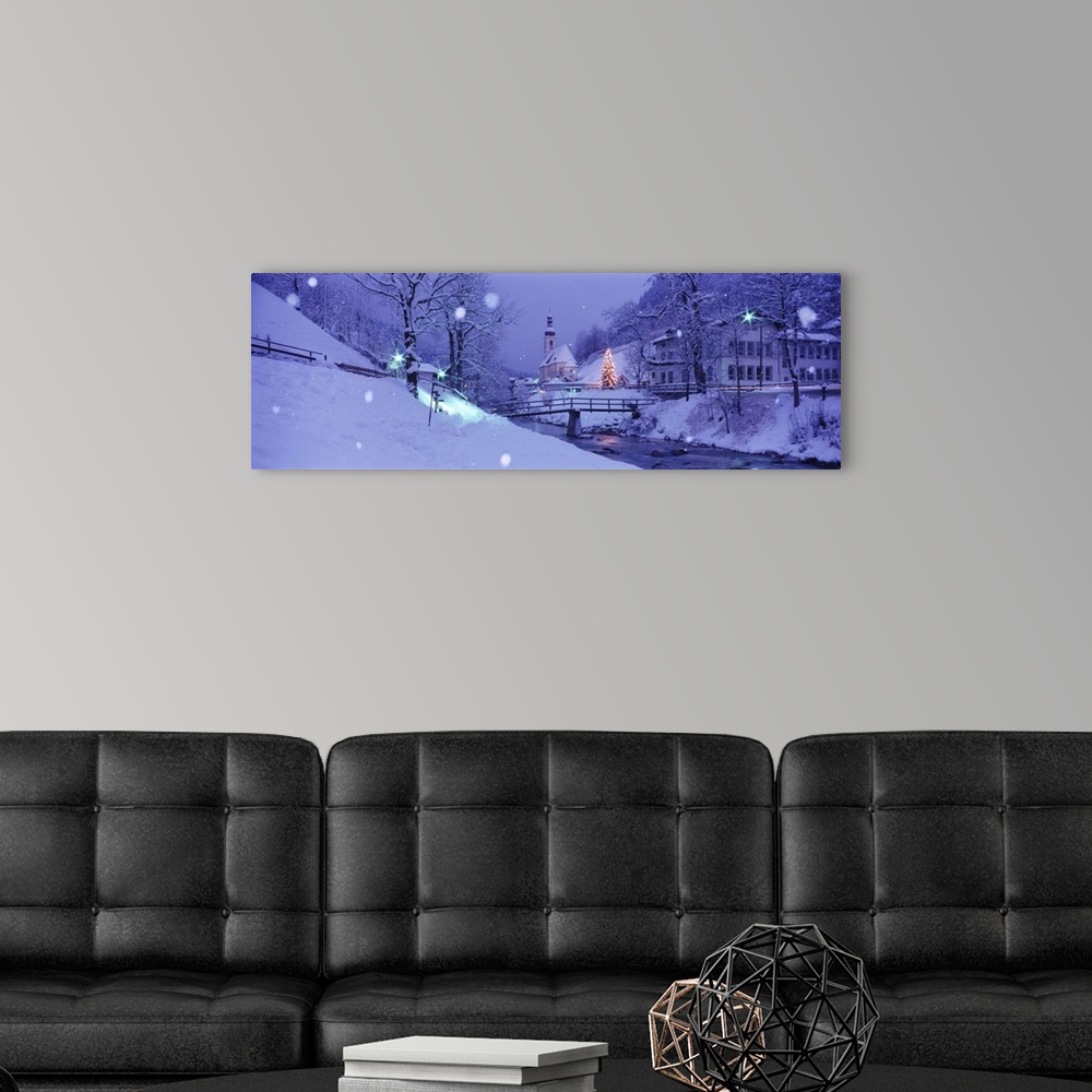 A modern room featuring Panoramic photograph taken of a snow covered landscape filled with bare trees.  The church in the...