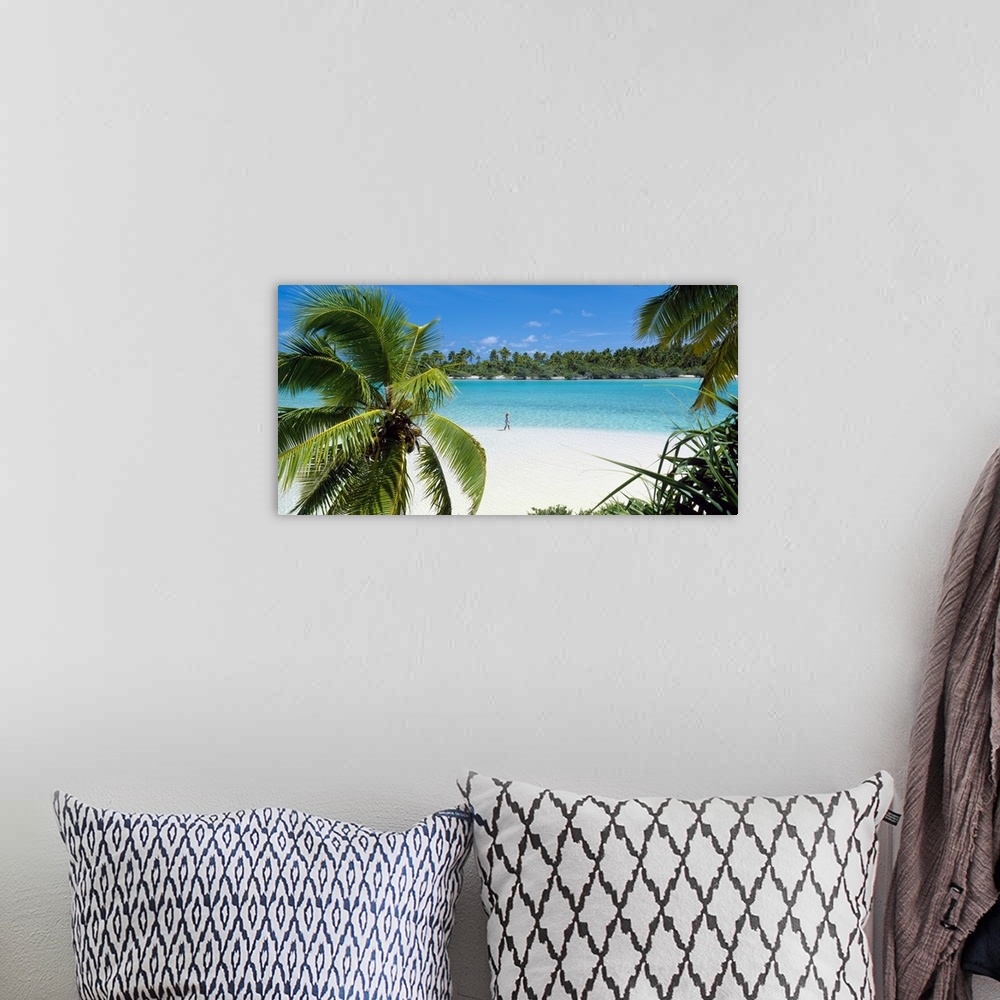 A bohemian room featuring Photograph of a lady walking alone on a white sand beach surrounded by crystal clear water and pa...