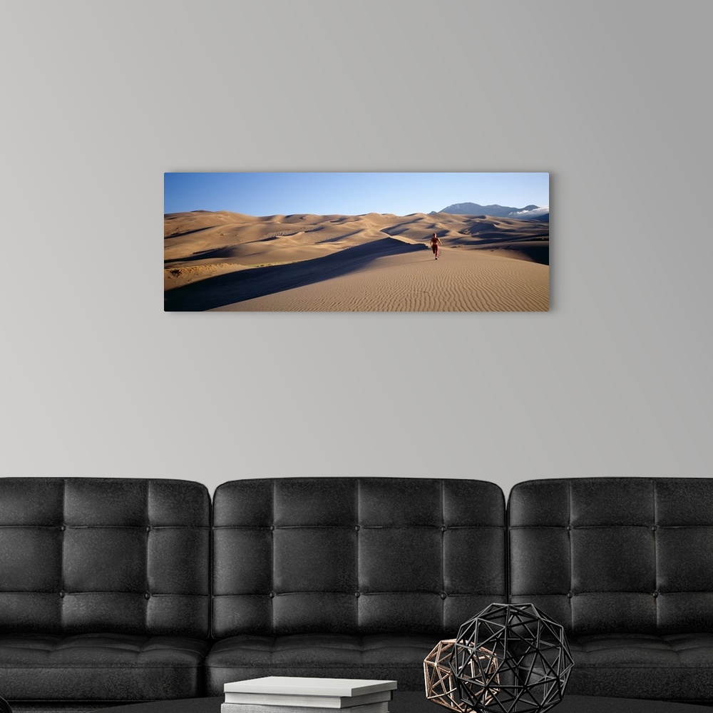 A modern room featuring Woman running in the desert, Great Sand Dunes National Monument, Colorado