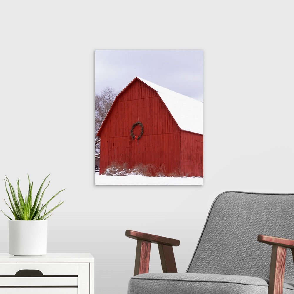 A modern room featuring Big photo on canvas of a farm building decorated for Christmas in the snow.