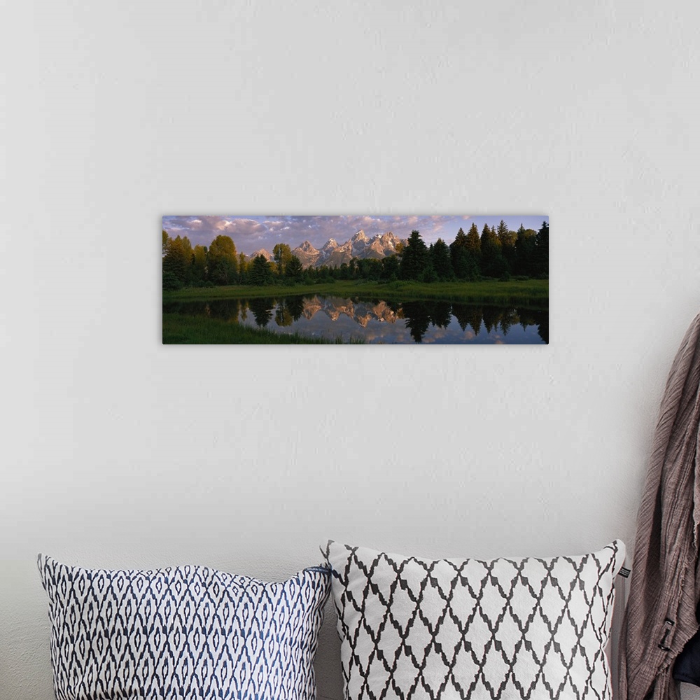 A bohemian room featuring Panoramic photograph of lake with forest in the background and snow covered mountains in the dist...