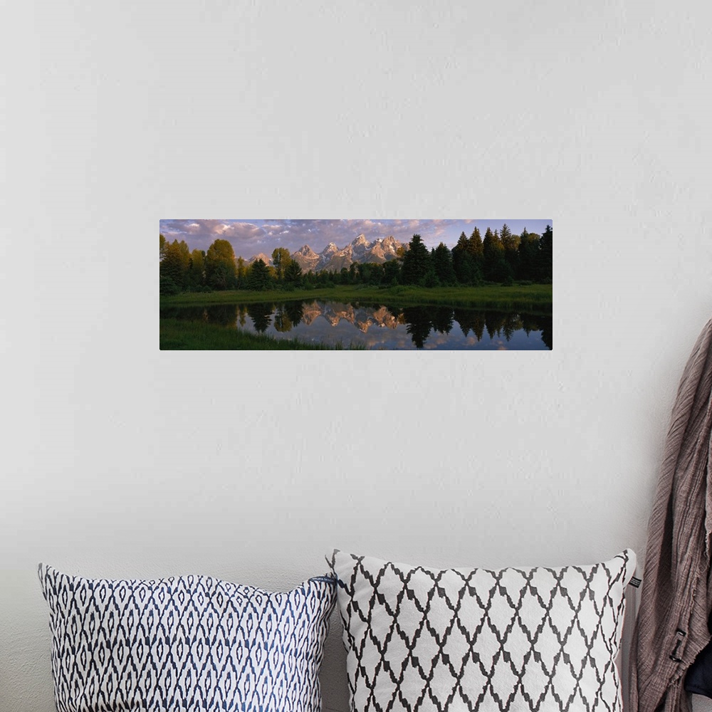 A bohemian room featuring Panoramic photograph of lake with forest in the background and snow covered mountains in the dist...