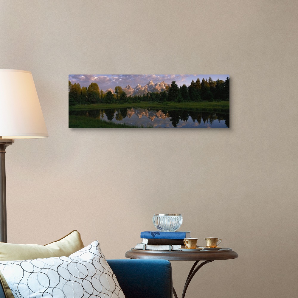 A traditional room featuring Panoramic photograph of lake with forest in the background and snow covered mountains in the dist...