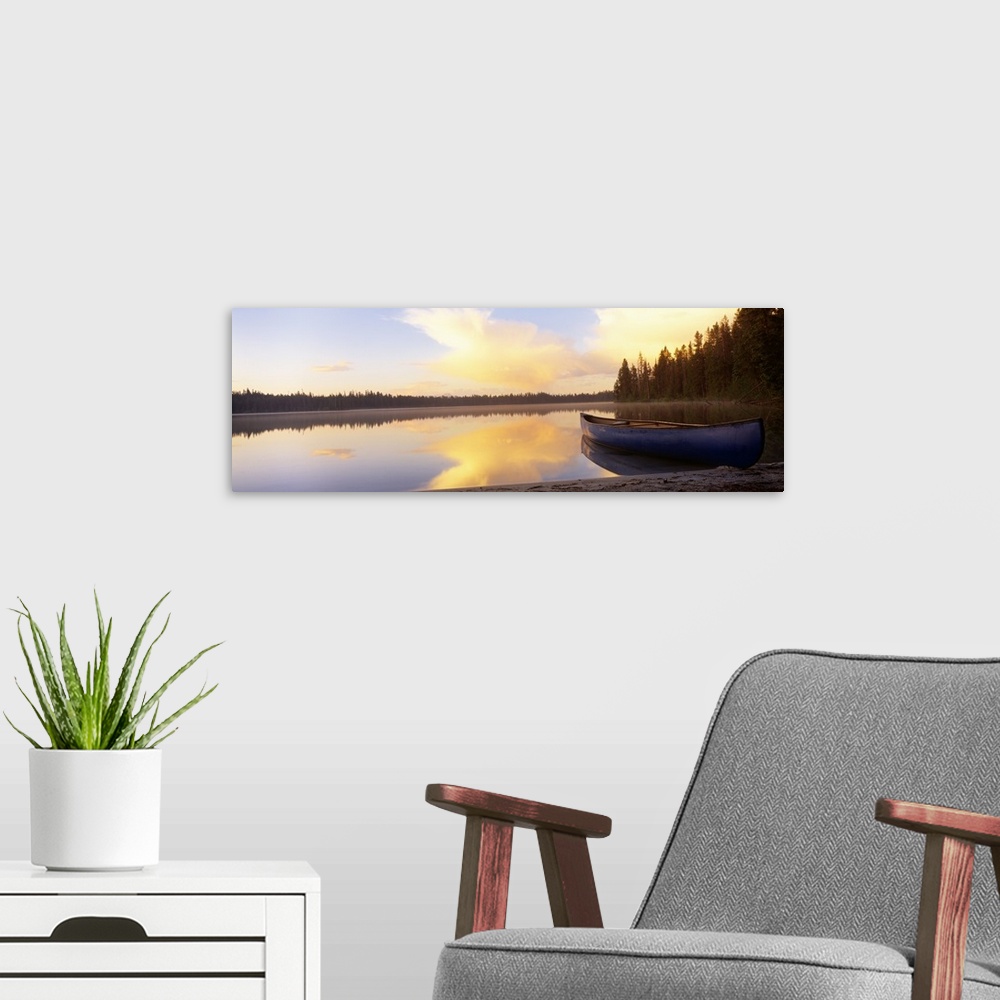 A modern room featuring Oversized landscape photograph of a partly cloudy sky and distant tree line, reflecting over the ...