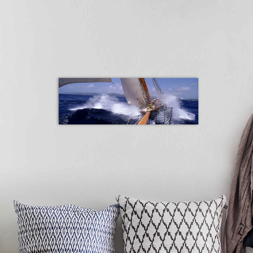 A bohemian room featuring Large, horizontal photograph of two yachts racing in rough waves of the Caribbean.  One boat is i...