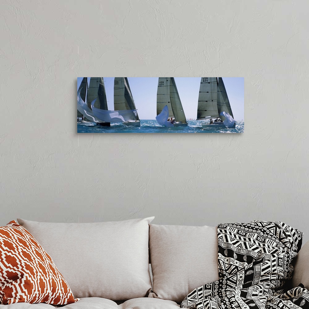 A bohemian room featuring Giant, wide angle photograph of five yachts racing on a sunny day, in the waters of Key West, Flo...