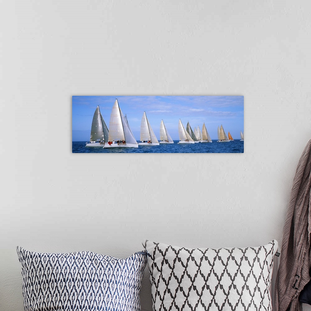A bohemian room featuring Panoramic photograph taken of several yachts that are sitting in line with each other in the ocean.