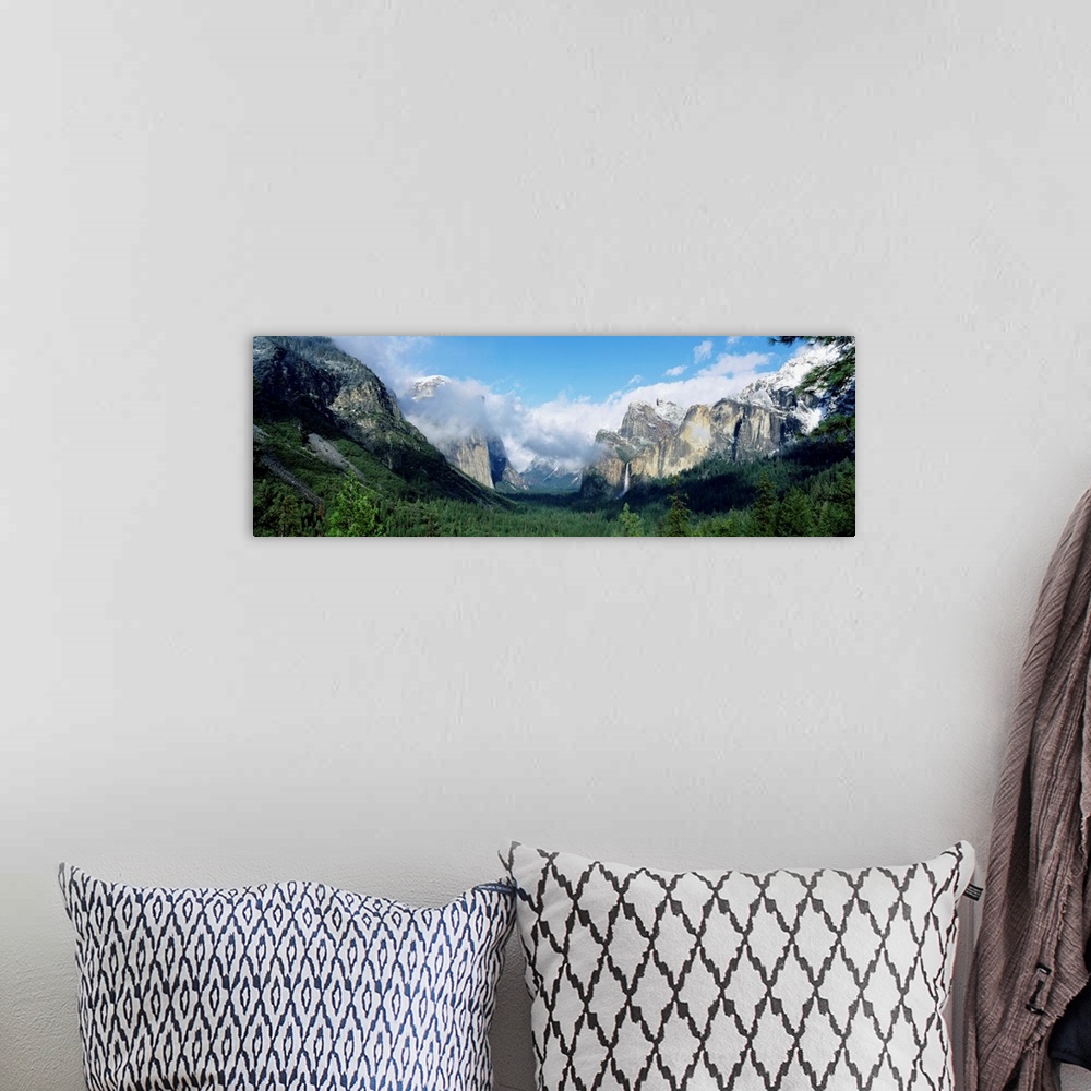 A bohemian room featuring Panoramic photograph shows a valley in Yosemite National Park filled with a dense forest of trees...