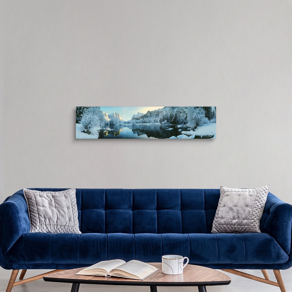A modern room featuring Giant, panoramic photograph of calm waters surrounded by snow covered trees and mountains in Yose...
