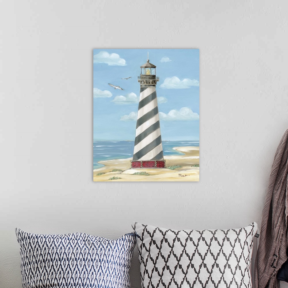 A bohemian room featuring Painting of the striped Cape Hatteras lighthouse on the Outer Banks with a few seagulls.