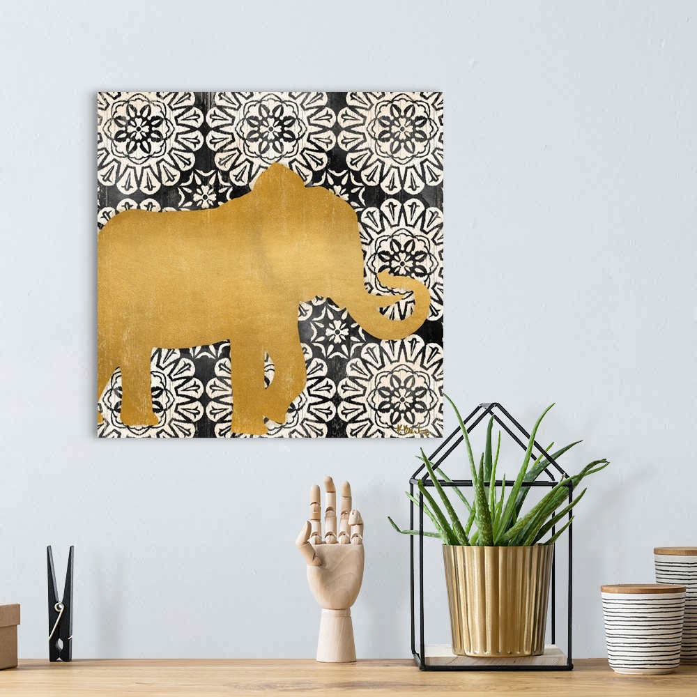 A bohemian room featuring Square decor with a metallic gold silhouette of an elephant on a black and white mandela patterne...