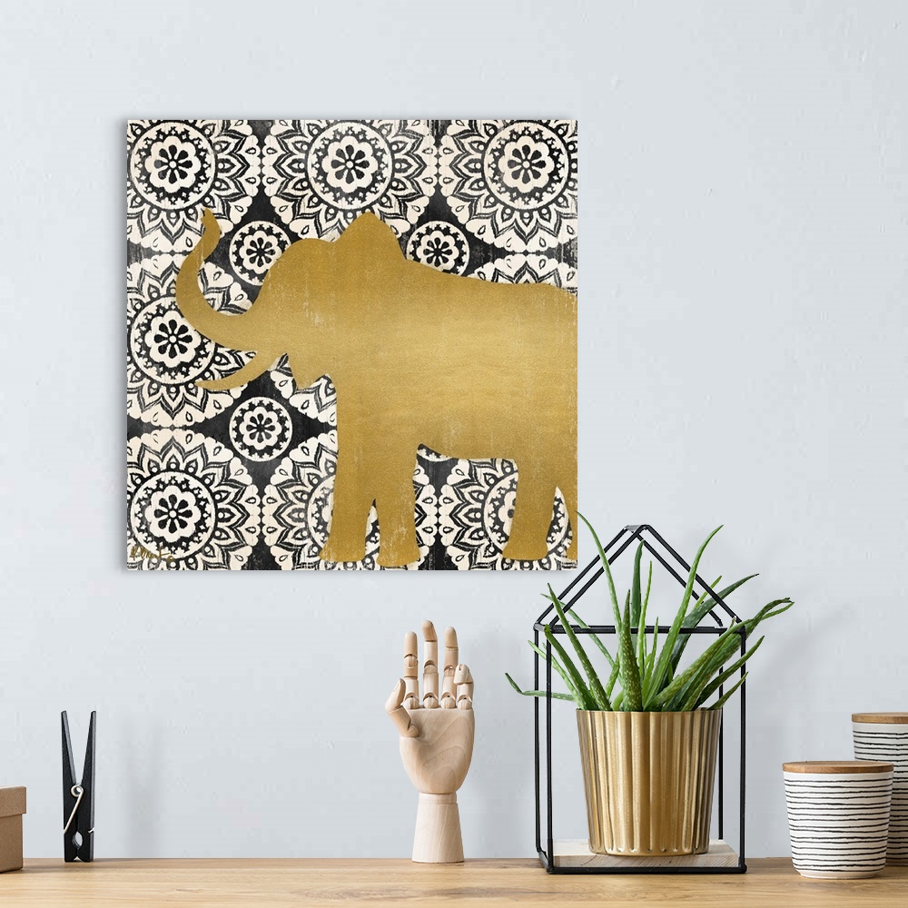 A bohemian room featuring Square decor with a metallic gold silhouette of an elephant on a black and white mandela patterne...