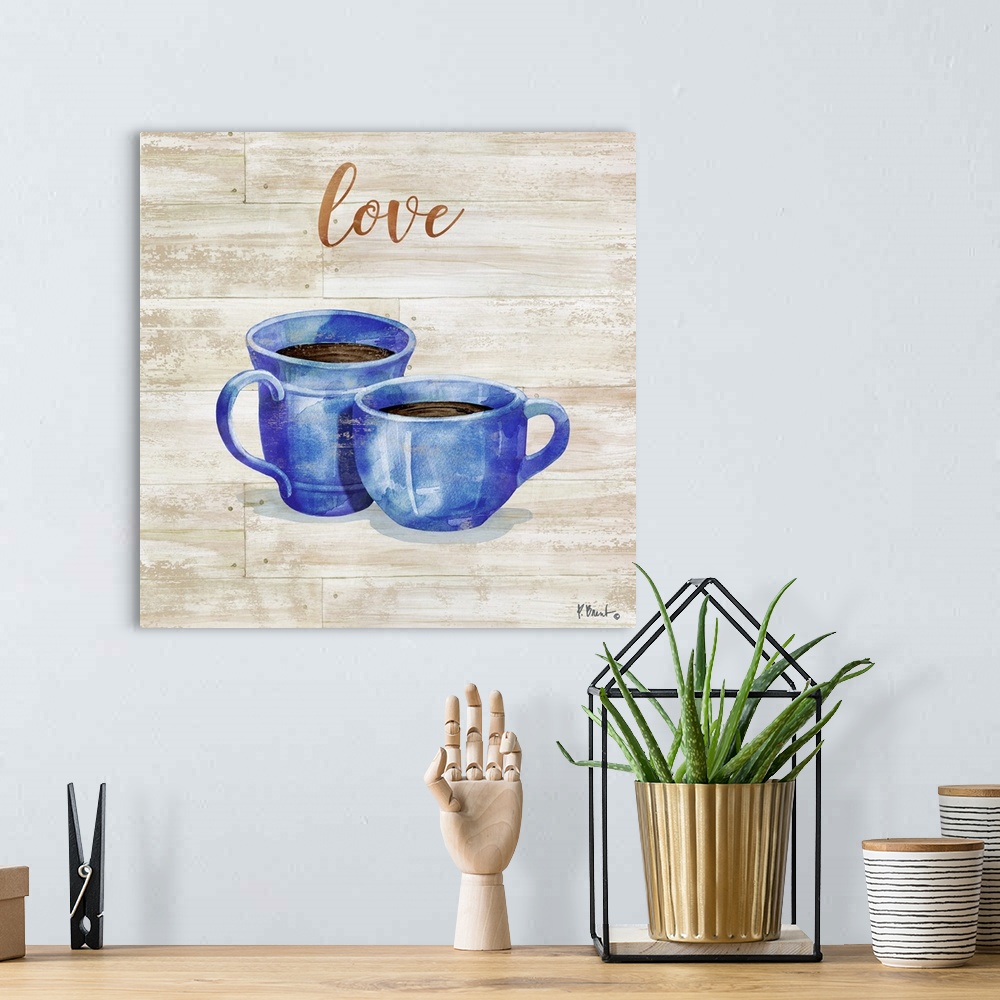 A bohemian room featuring Square decor with two mugs of coffee on a faux wood background with "love" written at the top.