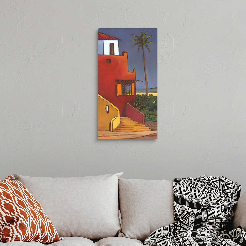 A bohemian room featuring Brightly colored painting of a Caribbean house with adobe walls and a palm tree.