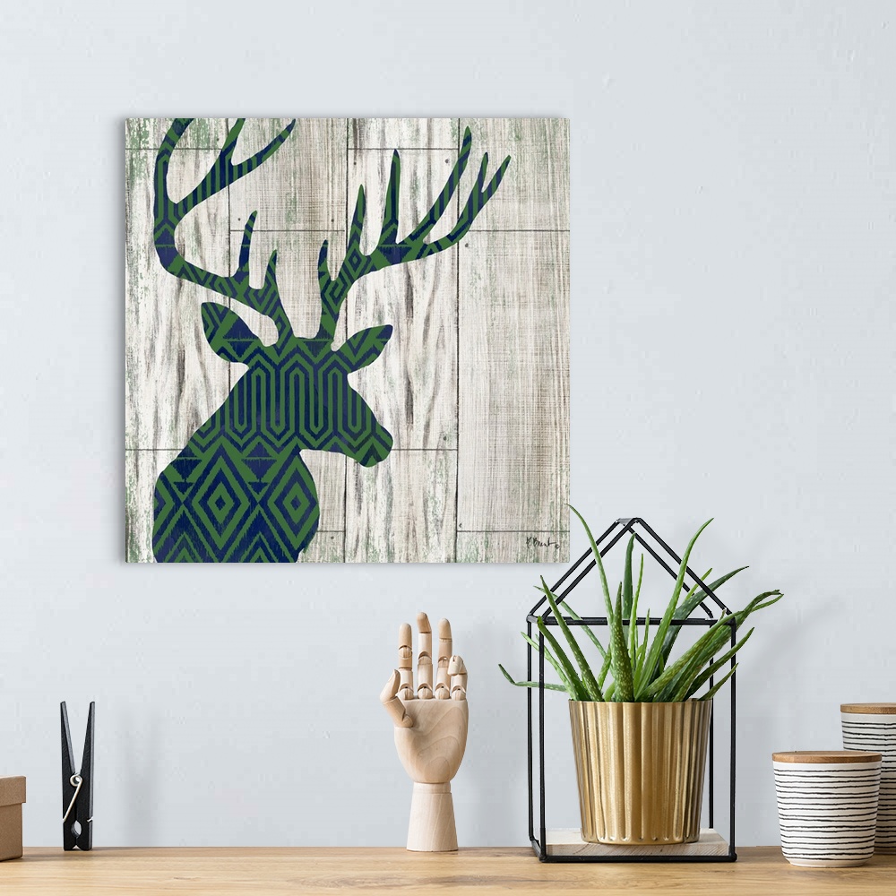A bohemian room featuring Square cabin decor with a blue and green patterned silhouette of a deer on a faux distressed wood...