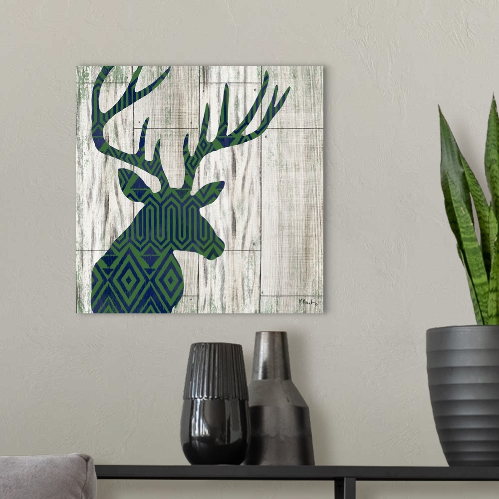 A modern room featuring Square cabin decor with a blue and green patterned silhouette of a deer on a faux distressed wood...