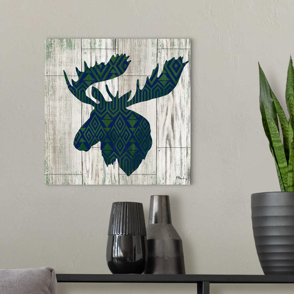 A modern room featuring Square cabin decor with a blue and green patterned silhouette of a moose on a faux distressed woo...