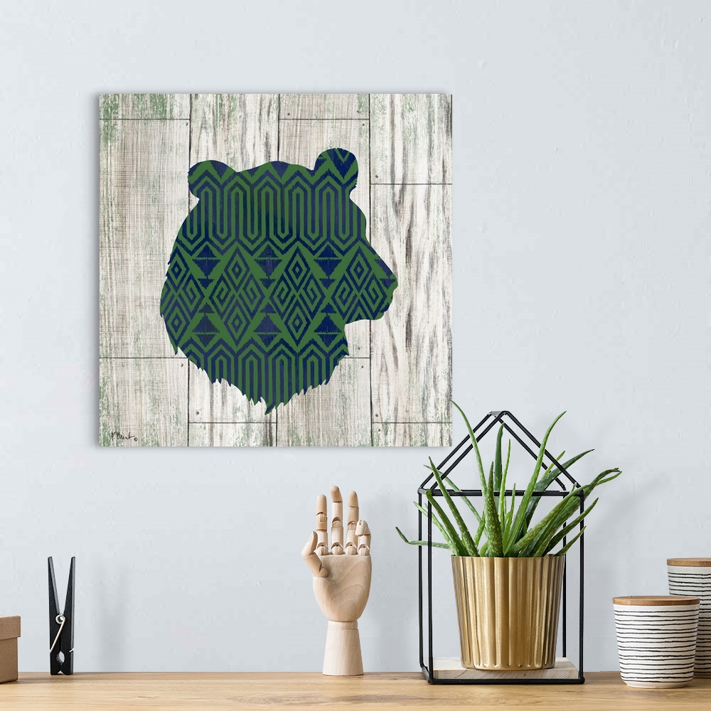 A bohemian room featuring Square cabin decor with a blue and green patterned silhouette of a bear on a faux distressed wood...