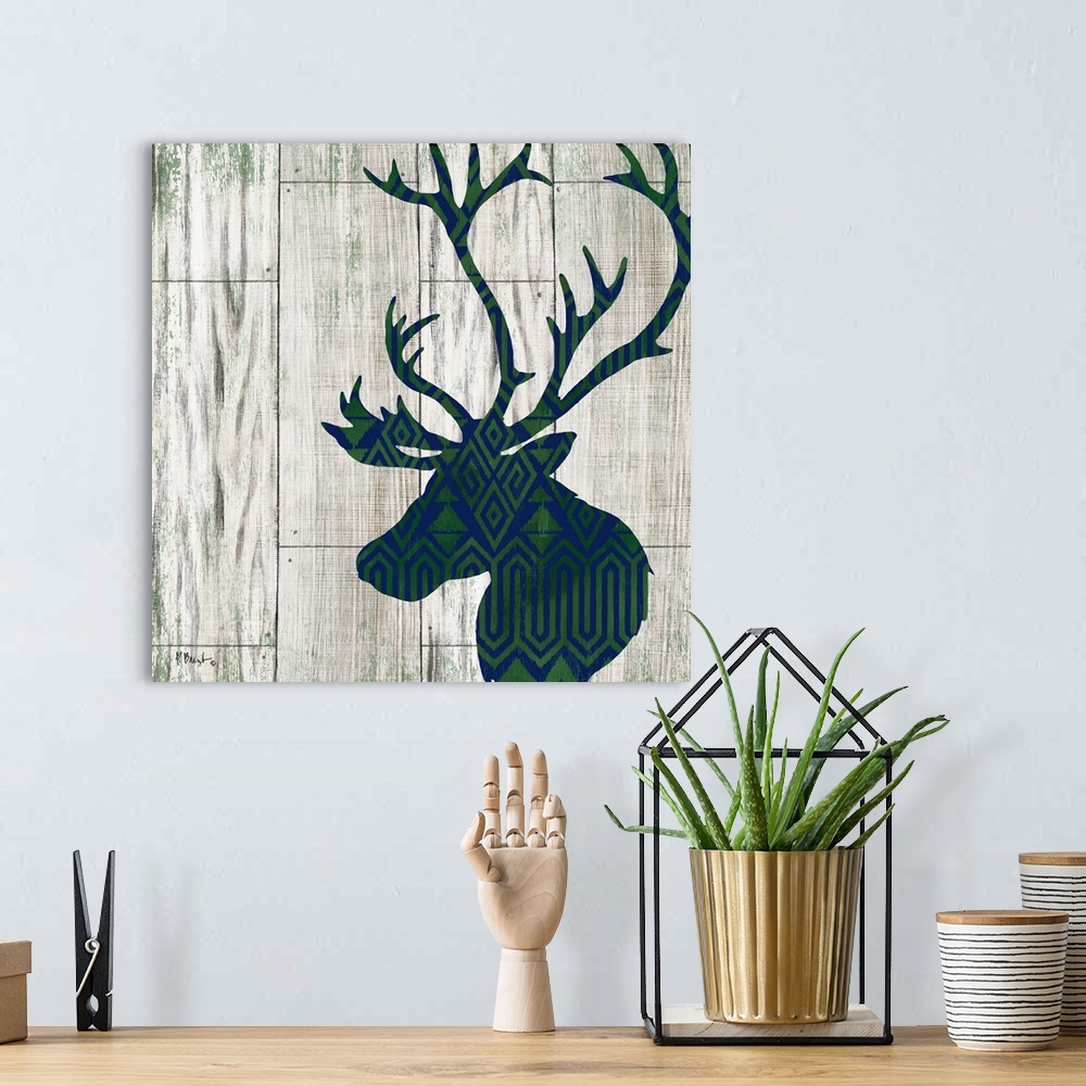 A bohemian room featuring Square cabin decor with a blue and green patterned silhouette of a deer on a faux distressed wood...