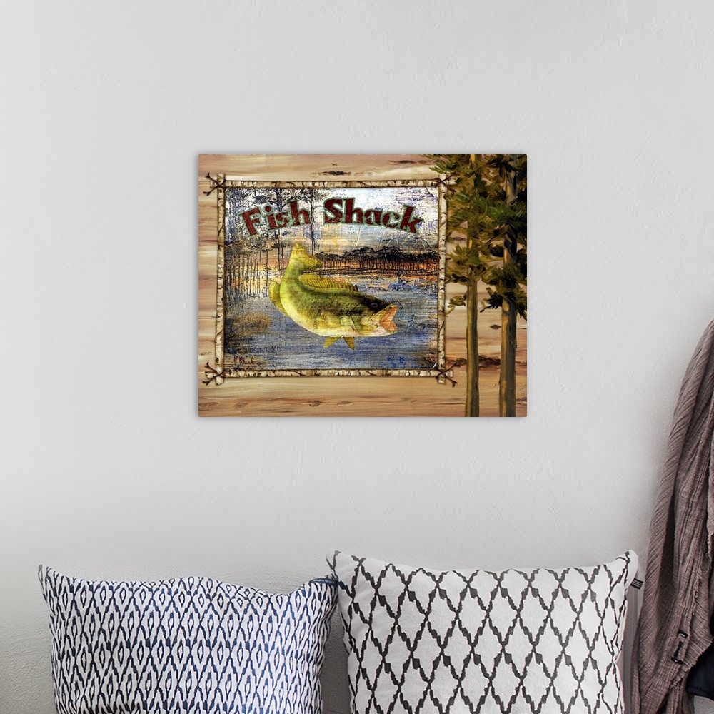 A bohemian room featuring Decorative artwork of a bass fish in a frame, with trees and the words Fish Shack.