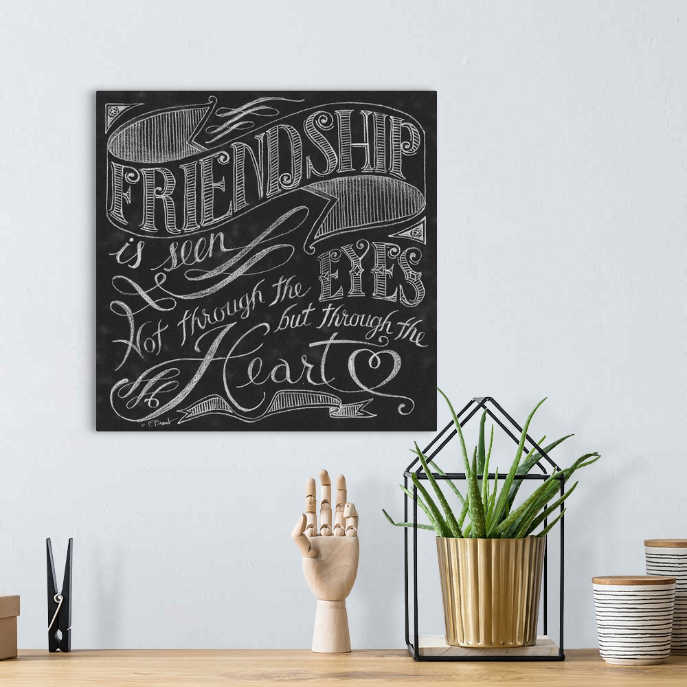 A bohemian room featuring Typography art of an inspirational quote about friendship, done in a chalkboard art style.