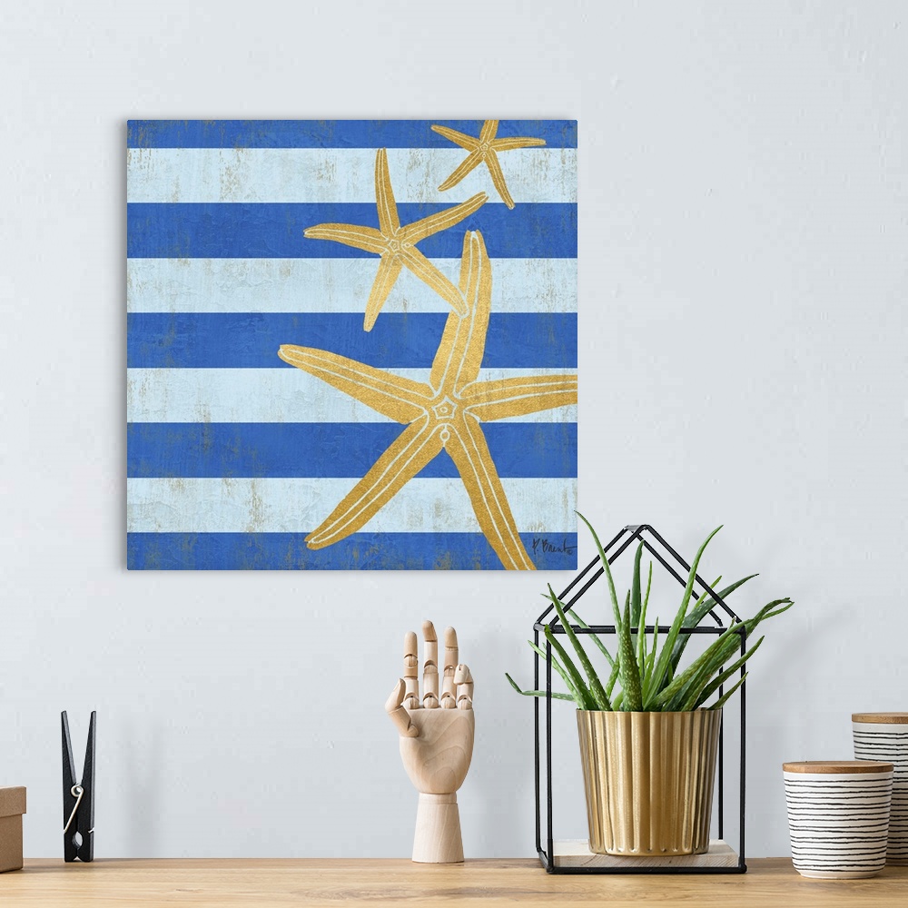 A bohemian room featuring Square decor with metallic gold starfish on a blue striped background.