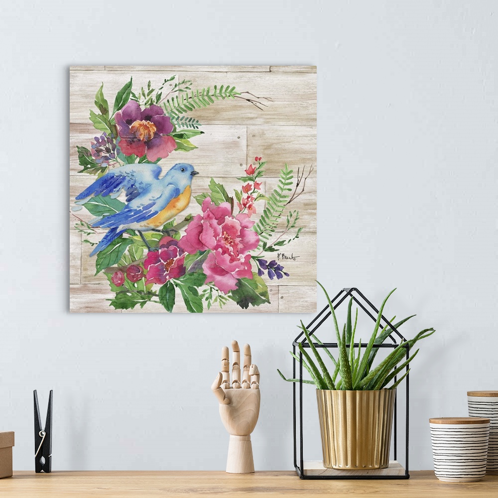 A bohemian room featuring Square decor with watercolor painted flowers and a blue and orange bird on a faux wood background.