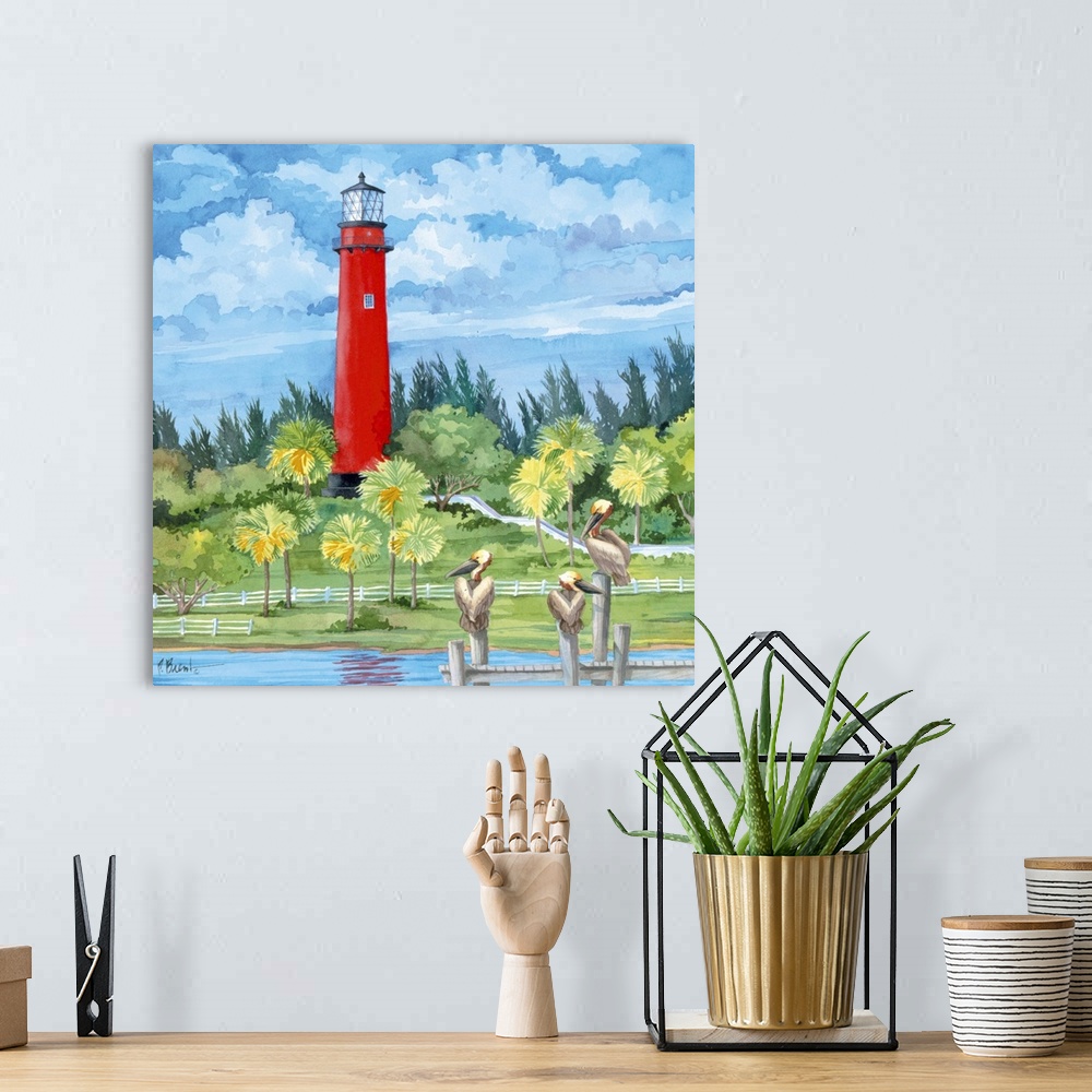 A bohemian room featuring Watercolor painting of a bright red lighthouse overlooking three pelicans perched on a pier.