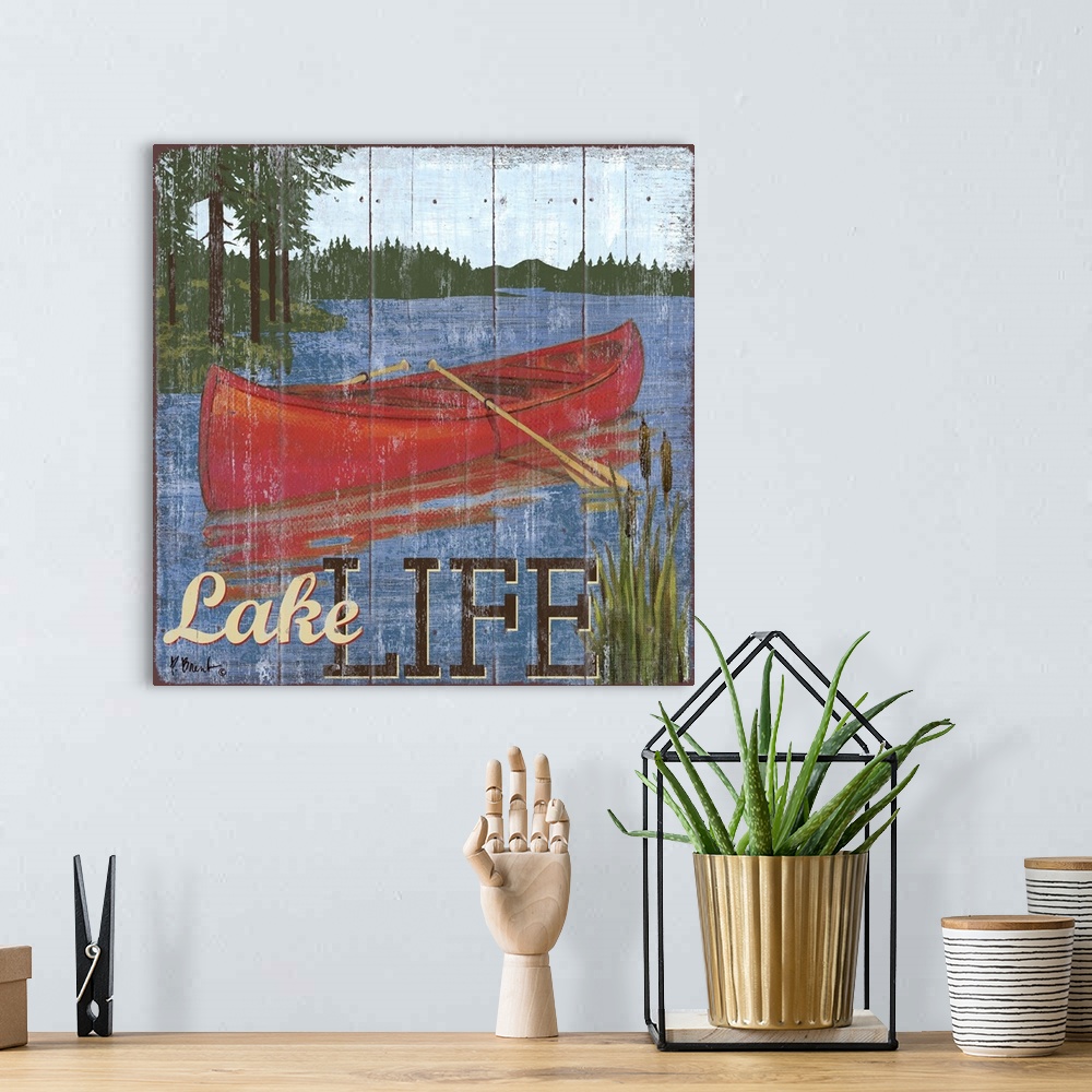A bohemian room featuring Decorative art of a canoe on a lake in the mountains on a textured panel background.