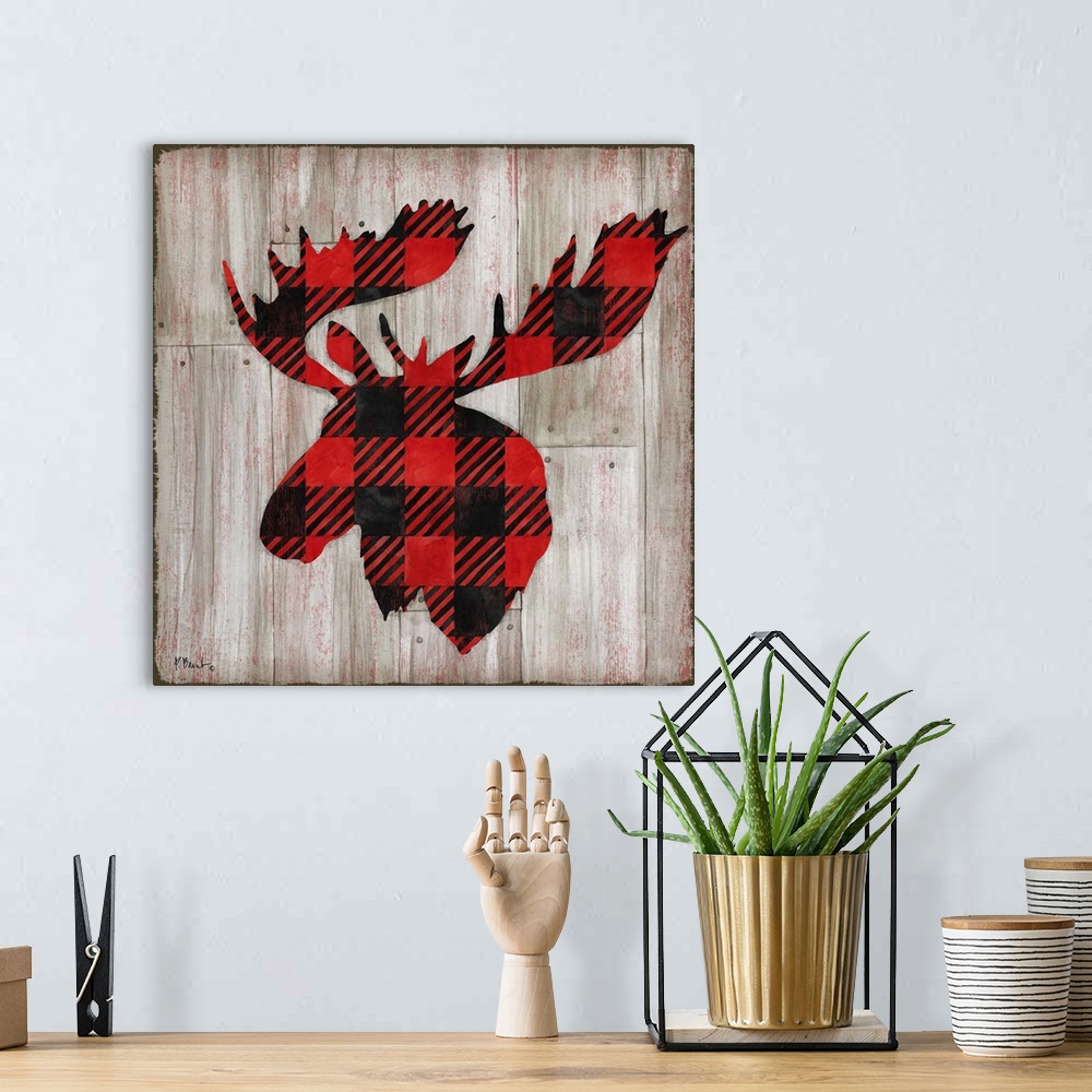 A bohemian room featuring Square cabin decor with a red and black flannel patterned silhouette of a moose on a faux distres...