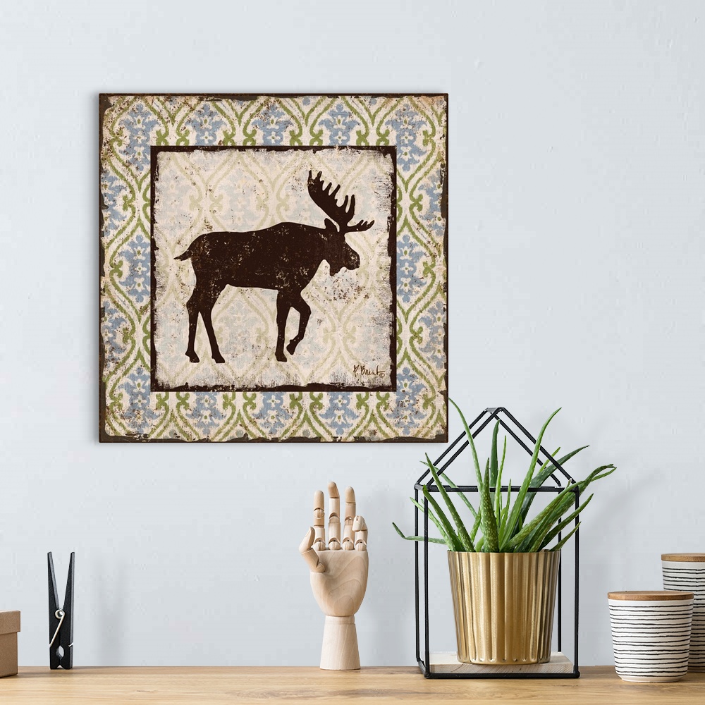 A bohemian room featuring Decorative square artwork featuring a silhouetted moose on a boho pattern.