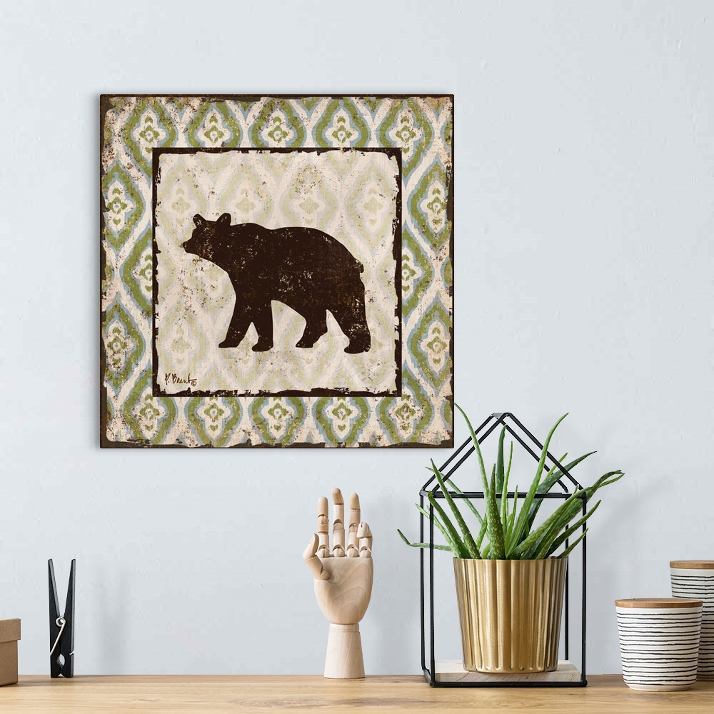 A bohemian room featuring Decorative square artwork featuring a silhouetted bear on a boho pattern.