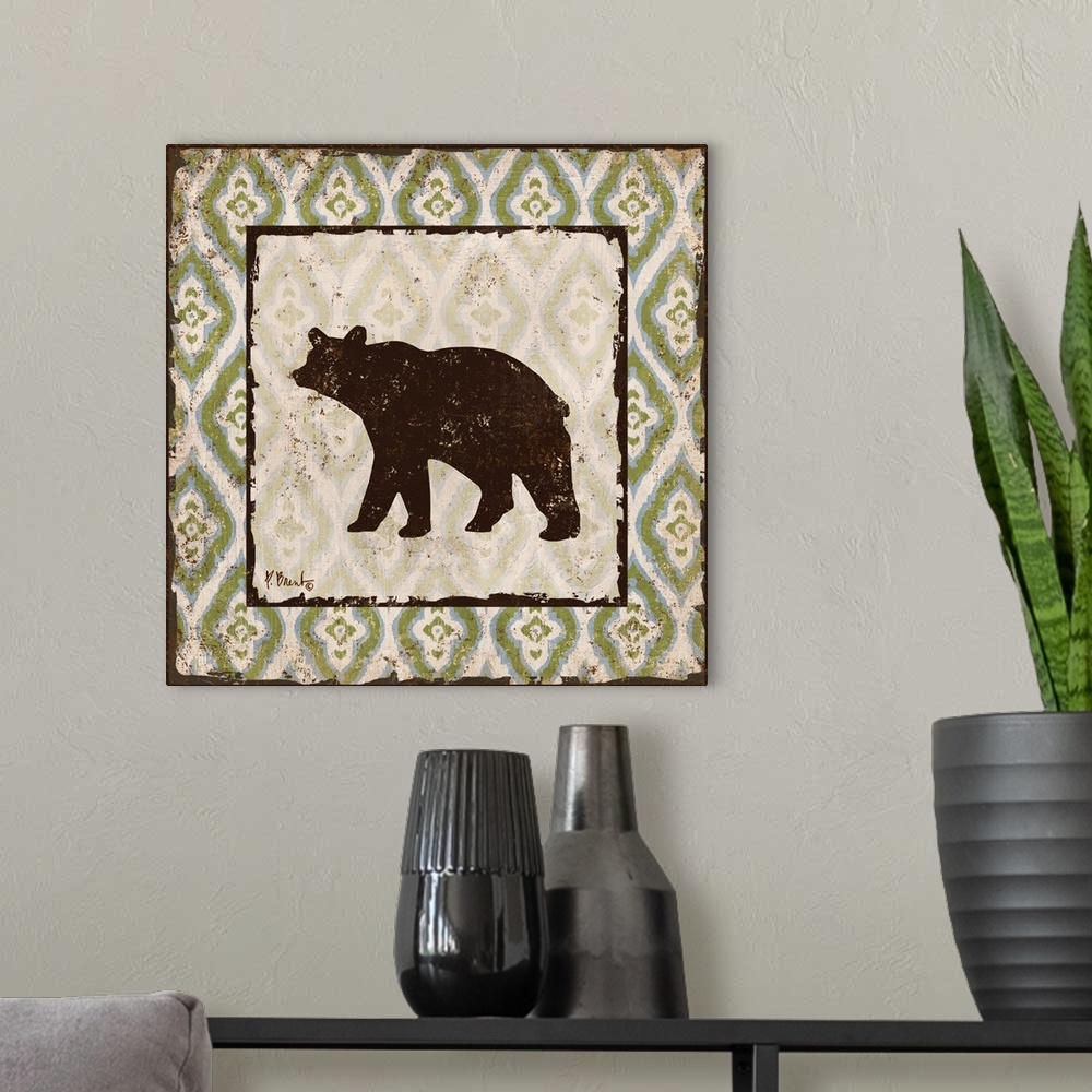 A modern room featuring Decorative square artwork featuring a silhouetted bear on a boho pattern.
