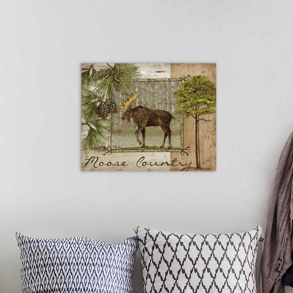 A bohemian room featuring Decorative artwork of a moose in a frame, with pine needles and pinecones, trees, and the words M...
