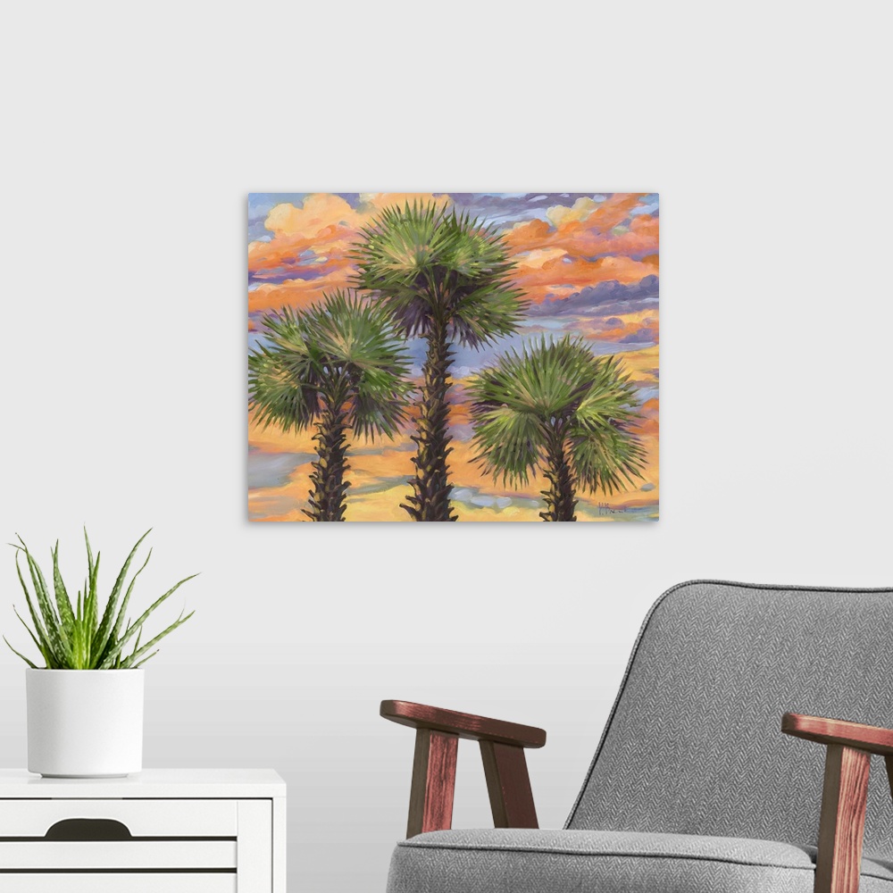 A modern room featuring A group of three palm trees against clouds illuminated by the sunset.
