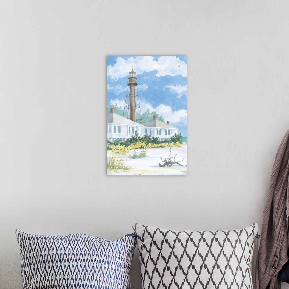 A bohemian room featuring Watercolor painting of a lighthouse with two beach houses on a sandy shore.