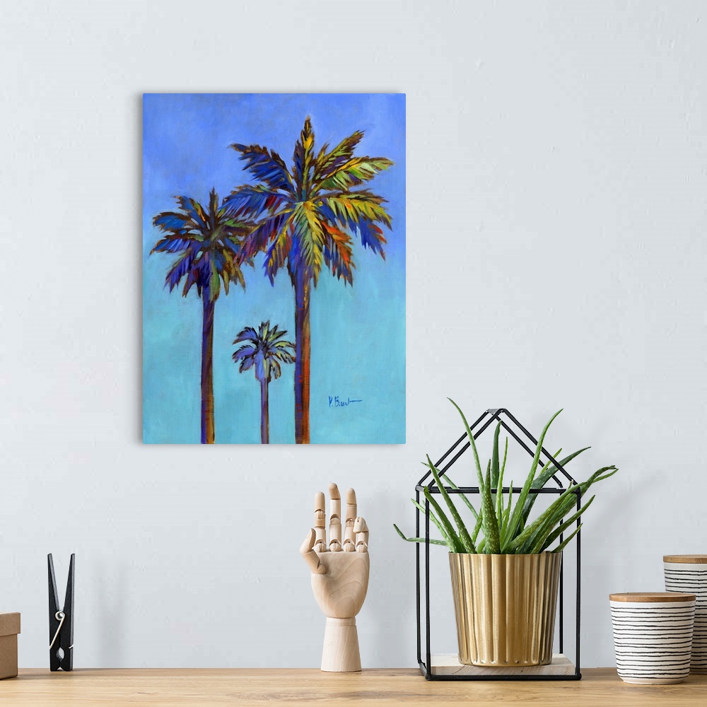 A bohemian room featuring Contemporary painting of three palm trees against a bold blue sky.