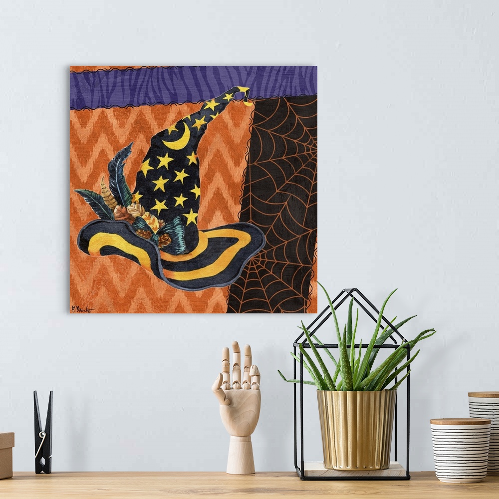 A bohemian room featuring Halloween themed artwork of a witch's pointy hat in festive purple and orange patterns.